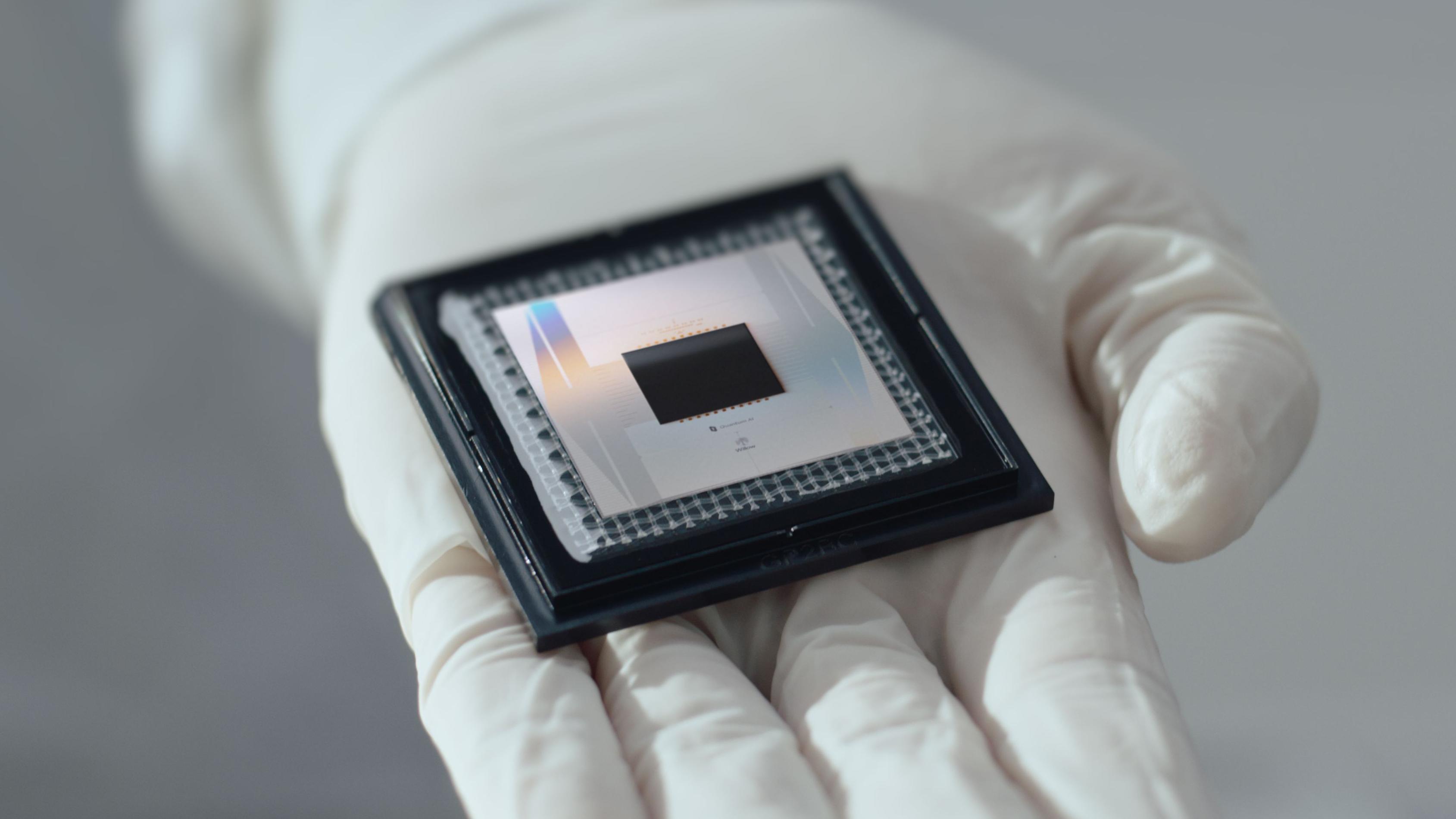 Photo of Google's quantum computing chip lying on a gloved hand
