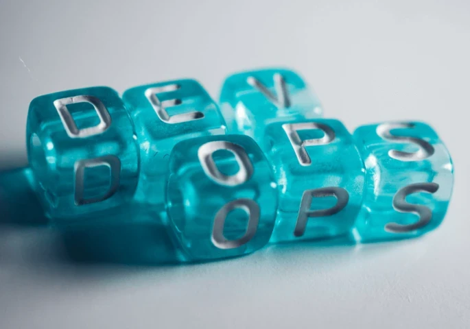 The word "DevOps" on blue blocks.