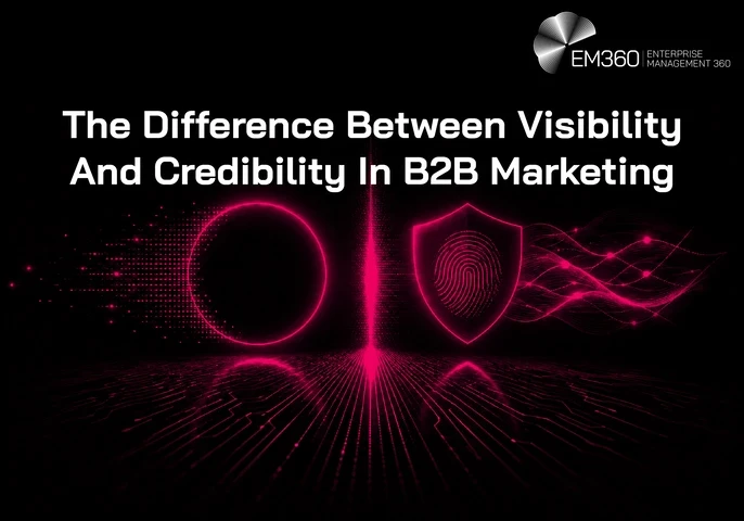 A black EM360 header graphic illustrating the difference between visibility and credibility in B2B marketing. On the left, a glowing pink circle formed from digital particles represents visibility and attention. On the right, a glowing shield containing a fingerprint represents credibility and trust, with flowing digital lines extending behind it. A bright vertical line divides the two concepts, while the article title appears prominently across the upper half of the image.