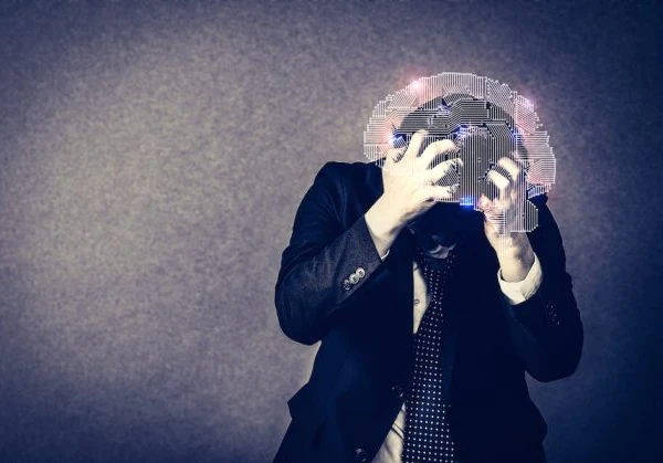 A business person in a suite holding his head in anguish