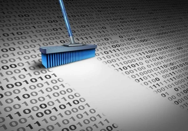 A broom cleaning up binary code.