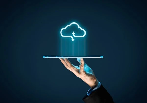 Hand holding up a tablet with a cloud icon floating above it.
