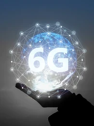 A hand holding up an animated ball signifying connectivity around the world with the word "6G" on it.