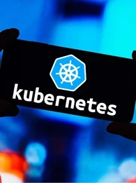 Hands holding up a smartphone with the screen displaying the word "Kubernetes"