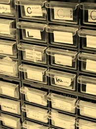 Old-fashioned clear storage boxes for spare parts in a warehouse