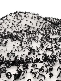 A bunch of black numbers spread out on white dunes.