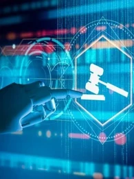 Robotic hand pointing to a gavel on a blue screen.