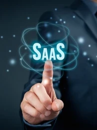 Person pointing to a sign that reads SaaS