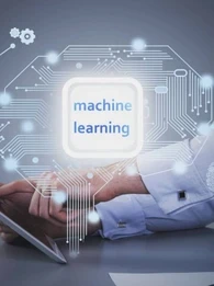 The words "machine learning" against a circuit board imagery and a person working on a tablet at a desk in the background.