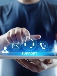 A person with a tablet pointing at the word "Support" with icons floating above.
