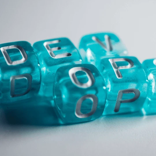 The word "DevOps" on blue blocks.