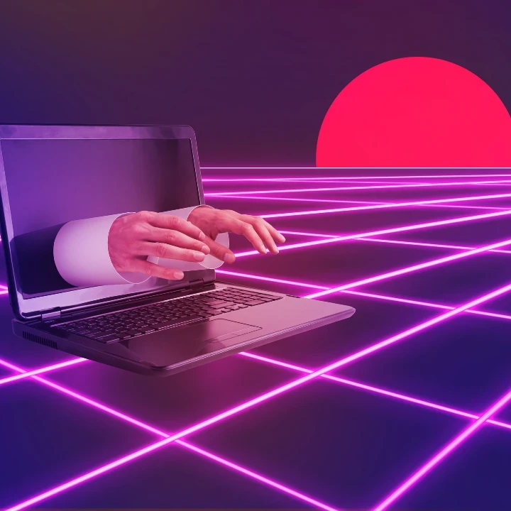 Hands reaching out of a laptop screen against an 80s-style neon background.