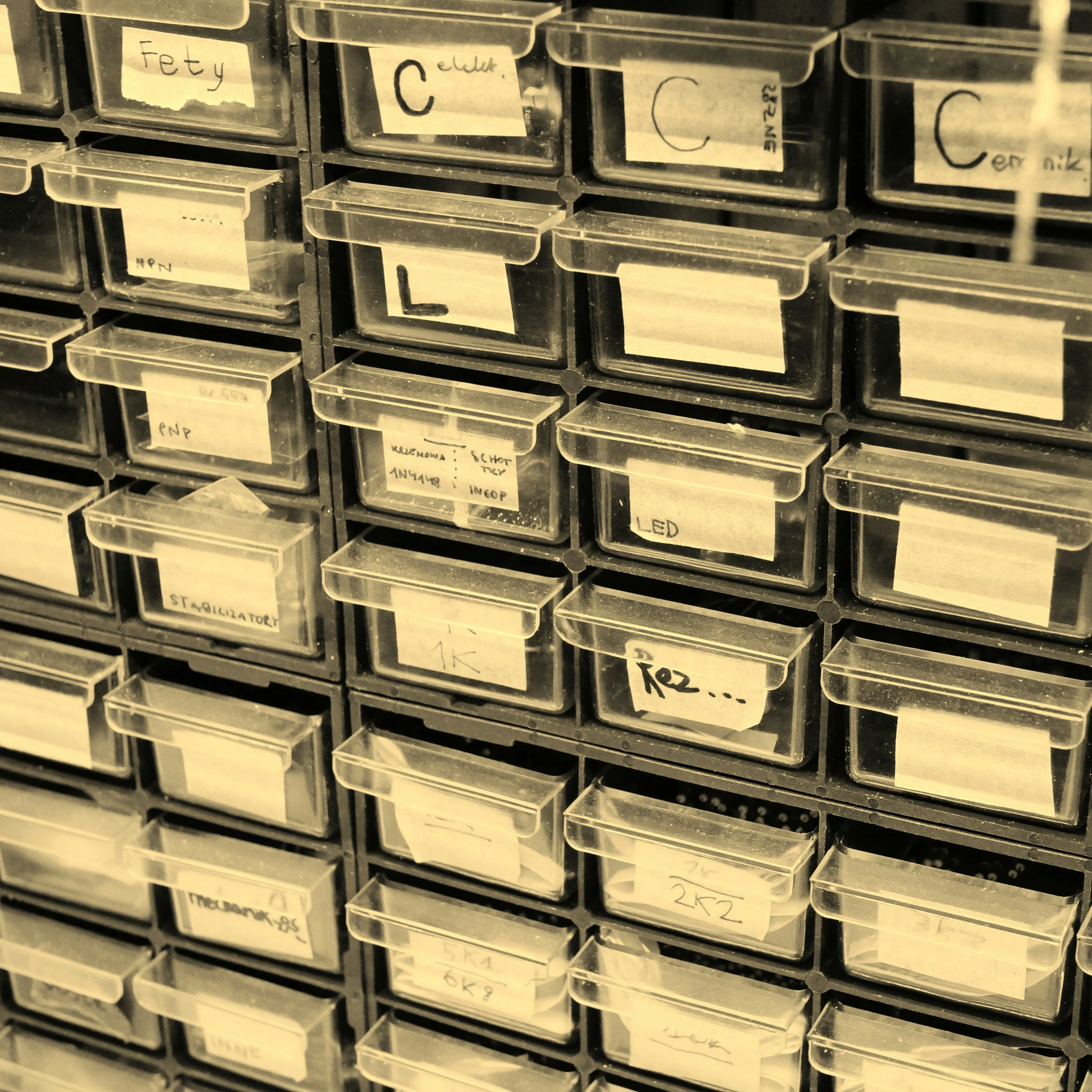 Old-fashioned clear storage boxes for spare parts in a warehouse