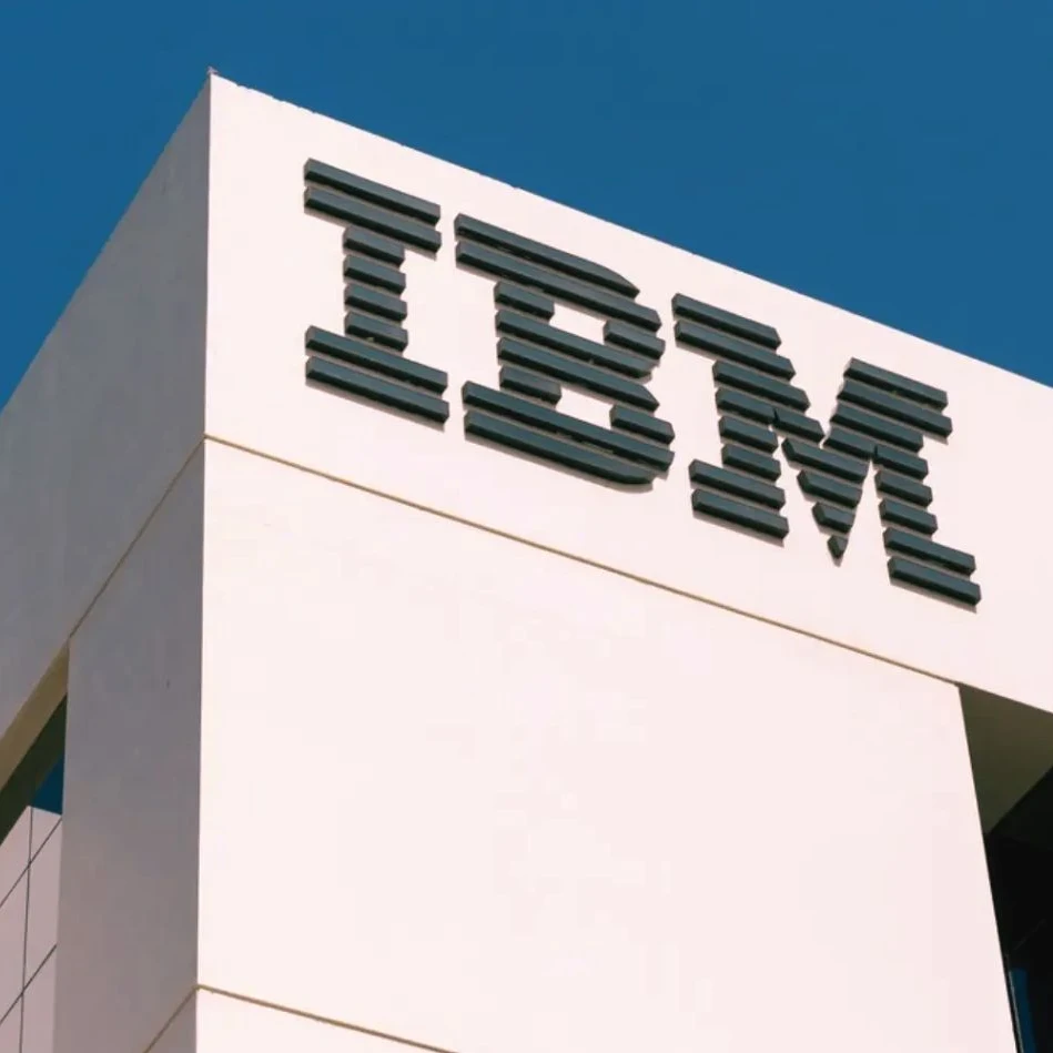 IBM logo on a white building with a blue sky above.