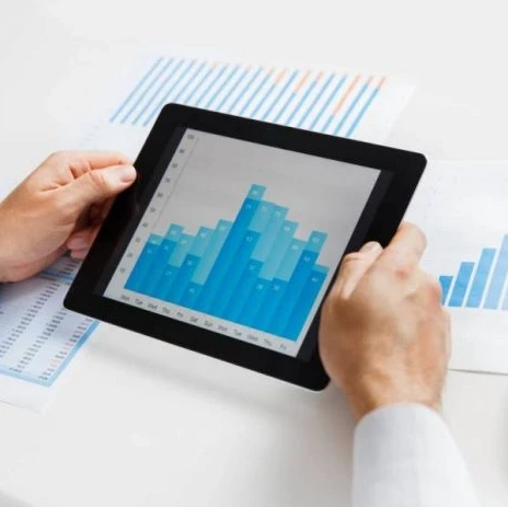 person holding a tablet with a graph