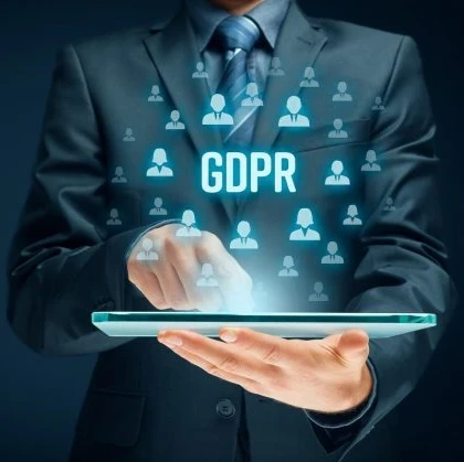 Businessman holding a tablet with the acronym "GDPR" floating above it.