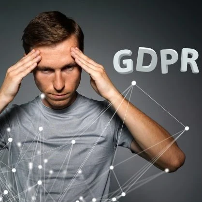Man in a grey shirt standing in front of animated strings with the words "GDPR" in the background.