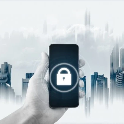 Padlock on a smartphone screen with a cityscape behind the phone
