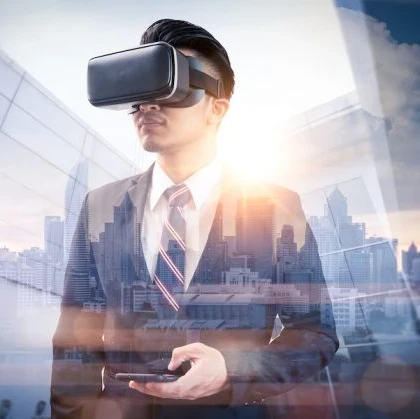 A businessman wearing virtual reality glasses and handling a smartphone against a cityscape.
