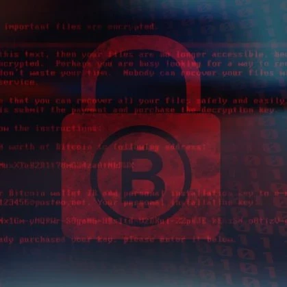 bitcoin logo on a padlock behind lines of code in red